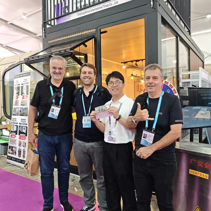 Three European buyers with CGCH sales rep at Canton Fair Xinjiang Kulus booth — USD bill in hand